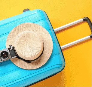 Blue suitcase with a straw hat and camera on a yellow background